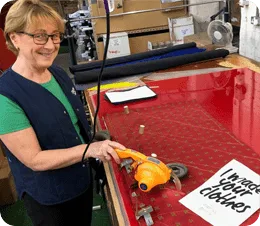 Keltic ties factory worker cutting recycled yarn fabric, one of the uk’s leading tie manufacturers producing custom club ties