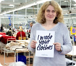 Keltic custom tie manufacturing worker holding an ‘i made your clothes’ sign