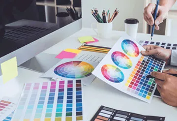 Colour swatches and design sketches on a desk, created by keltic's experienced club tie designers for custom tie orders