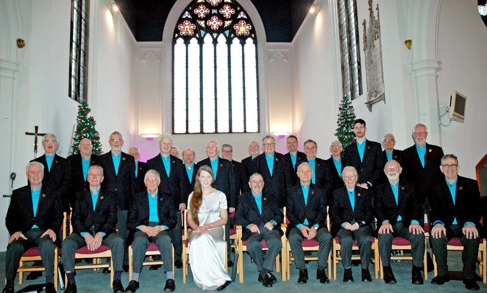 Choir uniform ideas: how loughborough male voice choir found its look | choir uniform ideas Loughborough male voice choir seated in a church wearing dark blazers and turquoise shirts